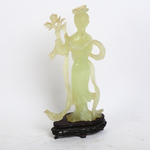 126 - A jadeite figure of a Chinese lady holding flowers on stand, H26cm