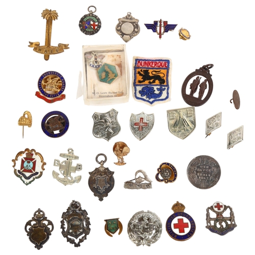 140 - A collection of enamelled and other badges, including military, Red Cross, fobs, etc