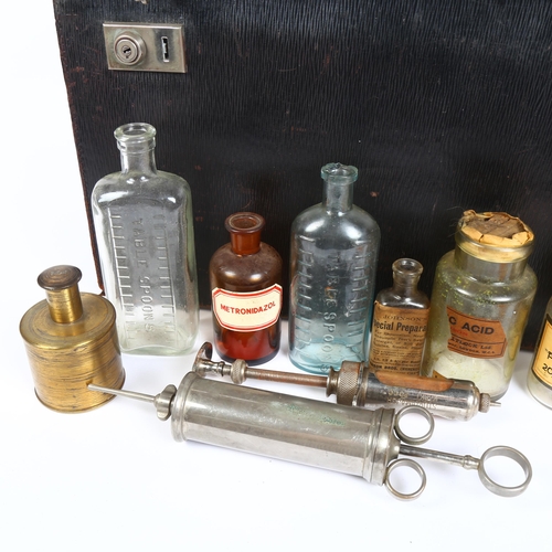 157 - An early 20th century leather physician's case, with various bottles and syringes, no maker's mark