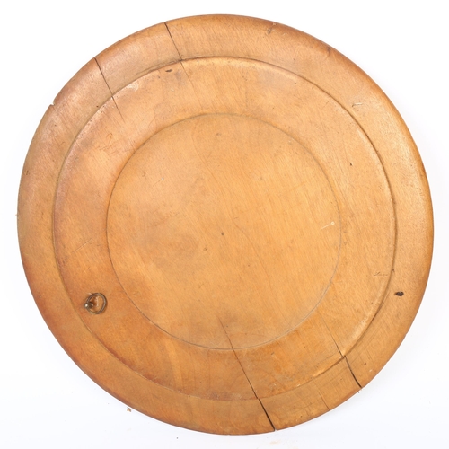 16 - A 20th century turned wood bread board, with applied leaf and floral decoration, diameter 32cm