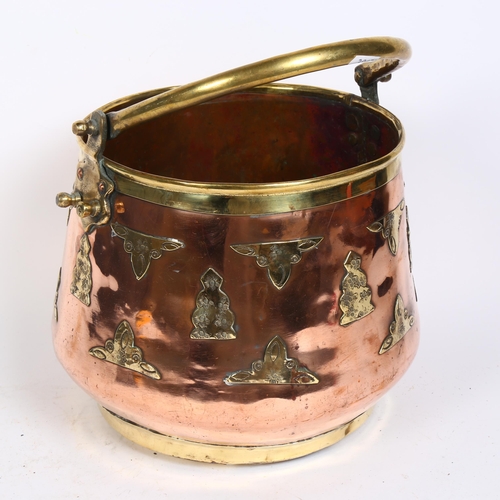 197 - An Indian polished brass and copper swing-handled bucket, with applied brass-work decoration, height... 