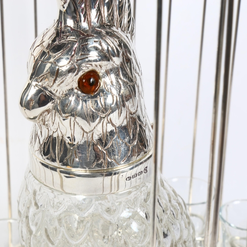 200 - A silver plated parrot design decanter and set of 8 glasses, set in a bird cage, H46cm