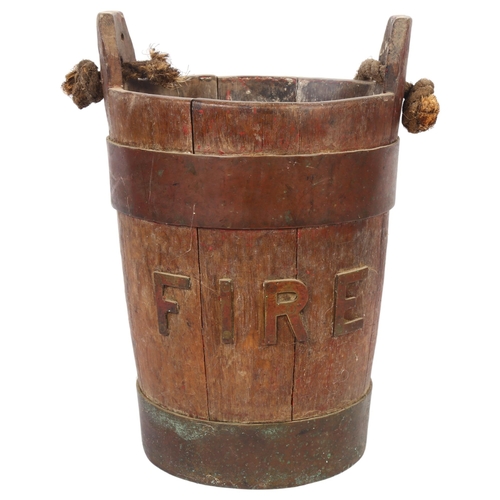 23 - A 19th century coopered oak fire bucket with rope handle, diameter 24cm, height 37.5cm
