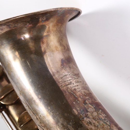 261 - HAWKES & SON - a large silver plated single reed saxophone, with associated wooden casing and variou... 