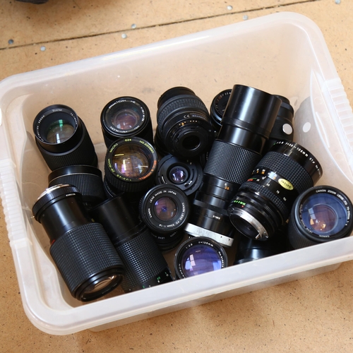 267 - A large quantity of camera lenses, including such brands as Canon, Bell & Howell, Praktica Photax et... 