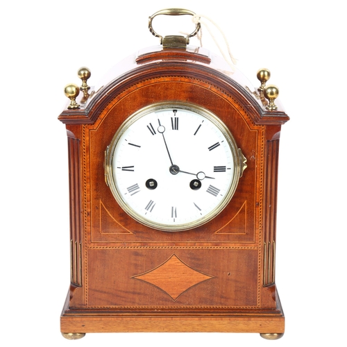 29 - An Edwardian mahogany and satinwood-banded arch-top mantel clock, white enamel dial with Roman numer... 
