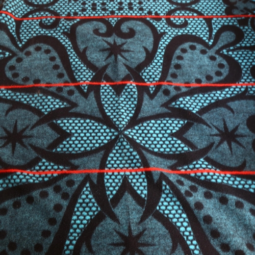 316 - A Seanamarena, an African wool blanket with turquoise coloured symmetrical design, 155 x 165cm