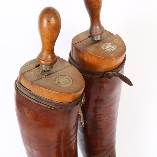 32 - A pair of early 20th century brown leather military riding boots and trees, boot height 49cm approx,... 