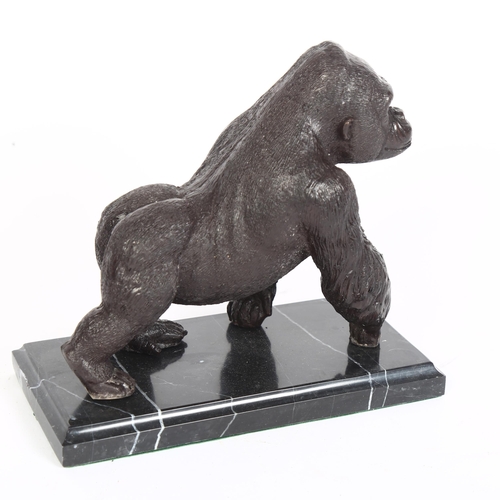 377 - A bronze statue of a gorilla, on a marble base, L20cm, H19cm, D10cm