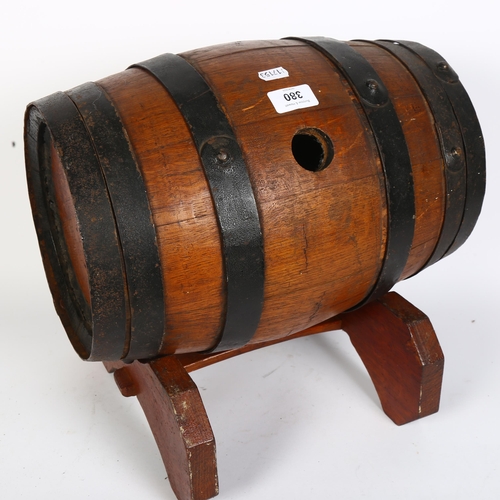 380 - A coopered oak barrel on stand, L37cm