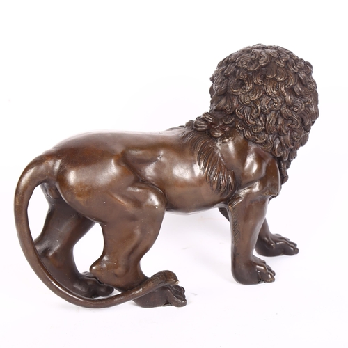 388 - A large bronze sculpture of a lion, L32cm