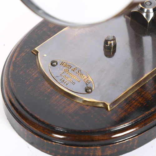 395 - A large reproduction magnifying lens on wooden base, label reads 