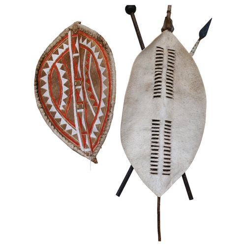 40 - An African Zulu shield, shield length 90cm, overall 143cm, and an African Masai shield, length 80cm,... 