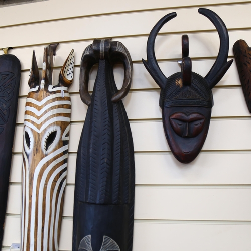41 - A group of 4 African carved wood masks, longest 80cm