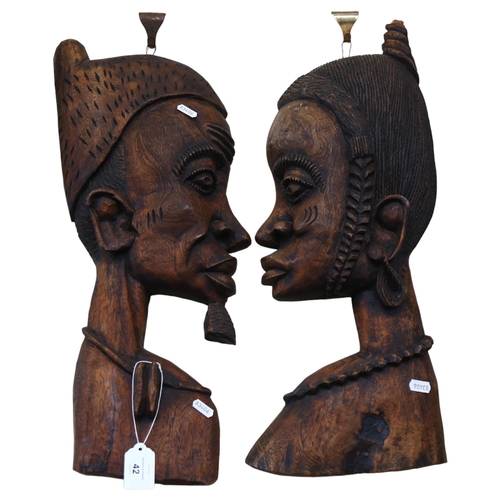 42 - A pair of African carved profile wall hangings, L60cm