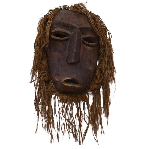 43 - A large Marli carved wood and rope mask, L50cm