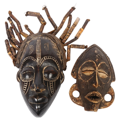 45 - A Congo style carved wood face mask, with leather strap and bamboo strands of hair, length 35cm, and... 