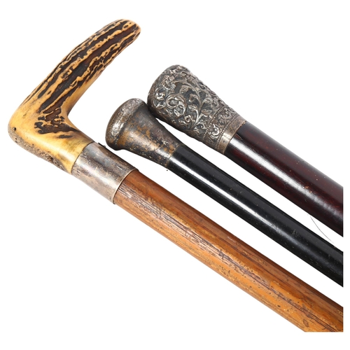 58 - A group of walking canes, to include an ebony and silver-topped cane, a Malacca cane with horn-handl... 