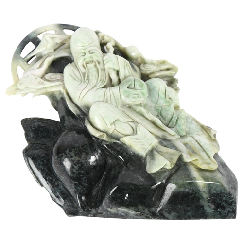 649 - An Oriental carved stone study of a sage and flying cranes, 24cm