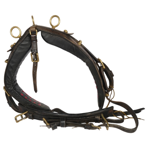 69 - An early 20th century leather and brass-mounted heavy horse collar, with straps