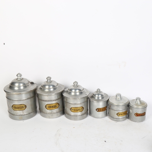 779 - A graduated set of 4 French aluminium storage jars and covers with brass plaques, a similar set of h... 