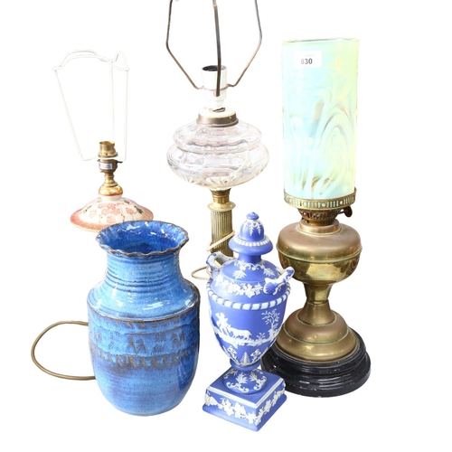 830 - A brass oil lamp, with an unassociated yellow vaseline glass shade, another oil lamp with glass font... 