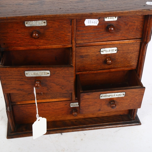 833 - An early 20th century oak table-top chest of 7 drawers, with aluminium name plates, including Girofl... 