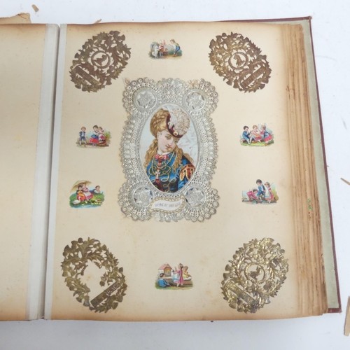 319 - A Victorian scrap album, and 2 other albums containing various Victorian postcards and greetings car... 