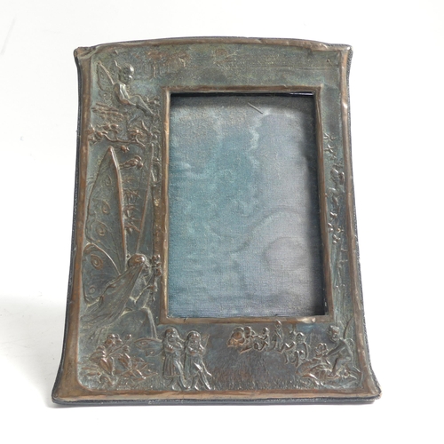 137 - An Art Nouveau embossed copper-mounted photo frame, and a 1920s oak photo frame with applied decorat... 