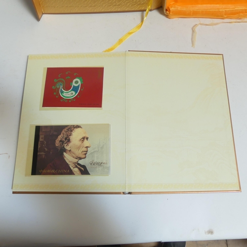 85 - An album of Chinese First Day Covers in presentation box, and an album of Chinese postage stamps