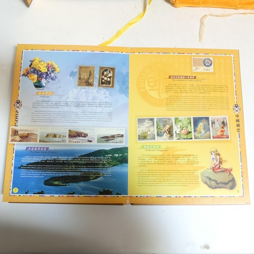 85 - An album of Chinese First Day Covers in presentation box, and an album of Chinese postage stamps