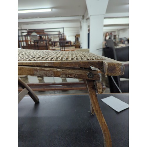 2630 - A vintage teak and cane panelled folding steamer lounge chair.