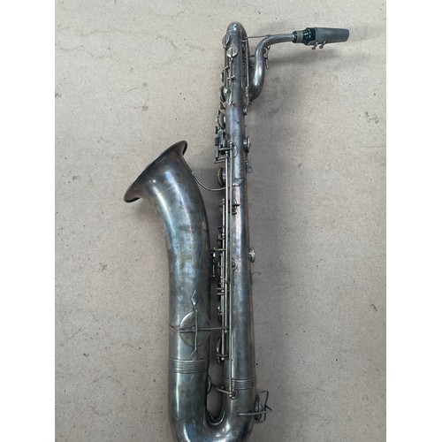 261 - HAWKES & SON - a large silver plated single reed saxophone, with associated wooden casing and variou... 