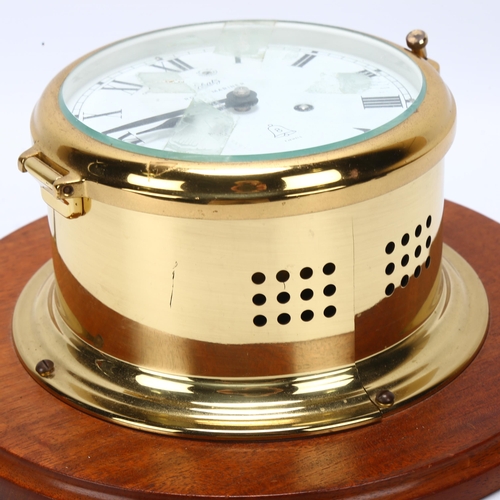 108 - A brass-cased ship's dial wall clock, Schatz Royal Mariner, 8-day striking movement, mounted on maho... 