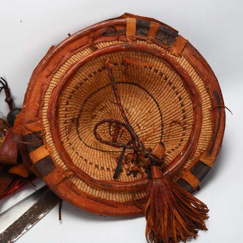 121 - Mandinka decorated leather sword and hat, and a Masai sword with red leather scabbard