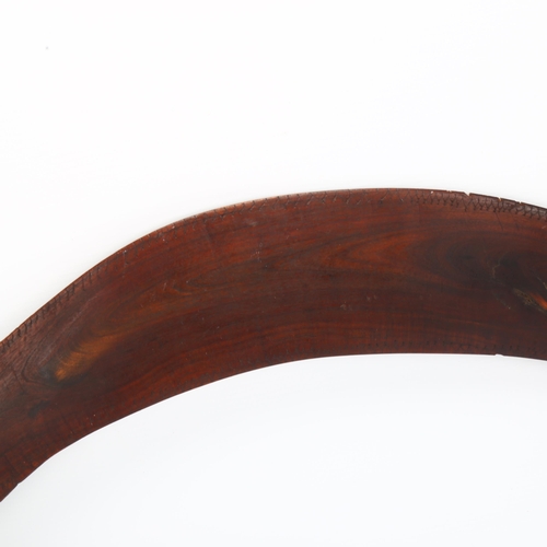 126 - A large Australian Aboriginal hardwood boomerang, with faint engraved geometric designs, length 87cm