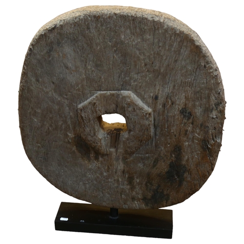 129 - An Ancient wooden cartwheel on modern stand, overall height 72cm