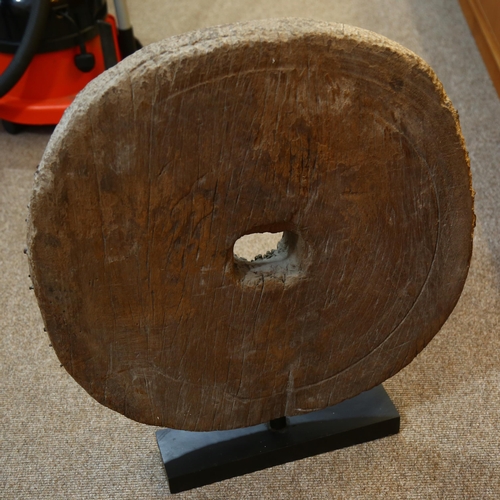 129 - An Ancient wooden cartwheel on modern stand, overall height 72cm