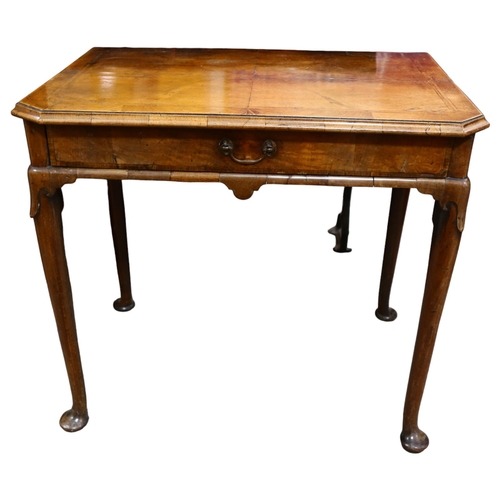 13 - George II Period walnut side table, the feather banded and quarter veneered canted top above a singl... 