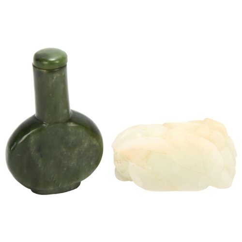 135 - A Chinese spinach jade snuff bottle and stopper, on carved white jade stand, height 8cm