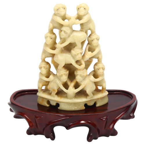 136 - A Chinese carved soapstone group of monkeys on wood stand, overall height 14cm