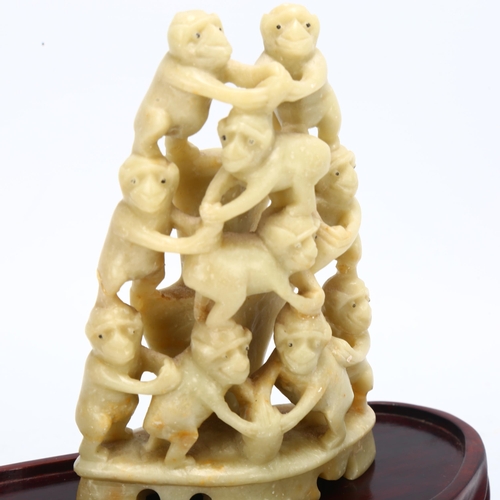 136 - A Chinese carved soapstone group of monkeys on wood stand, overall height 14cm