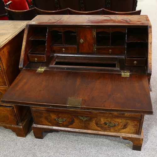 14 - An early 18th century walnut bureau, with stepped fitted interior, 2 short and 2 long drawers below ... 