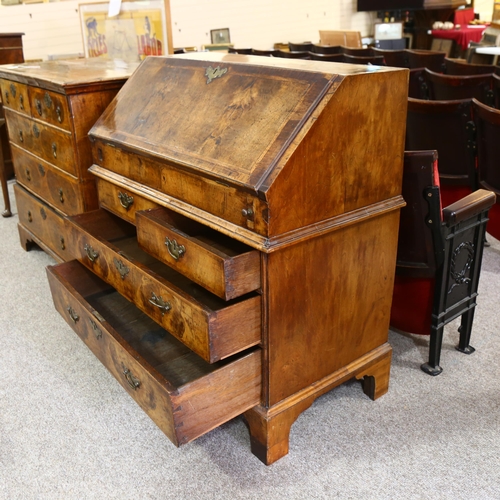 14 - An early 18th century walnut bureau, with stepped fitted interior, 2 short and 2 long drawers below ... 