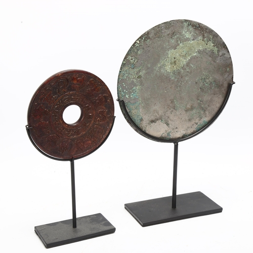 150 - A Chinese relief cast-bronze mirror, diameter 17.5cm, and a Chinese relief carved stone bi-disc, dia... 