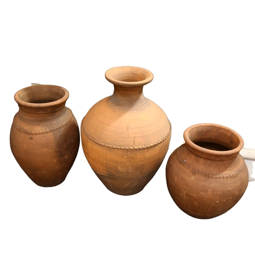 174 - 3 large Portuguese weathered terracotta olive jars, impressed makers mark to two smaller jars, talle... 