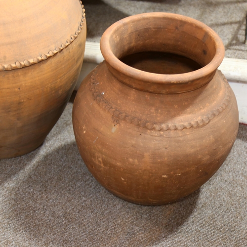 174 - 3 large Portuguese weathered terracotta olive jars, impressed makers mark to two smaller jars, talle... 