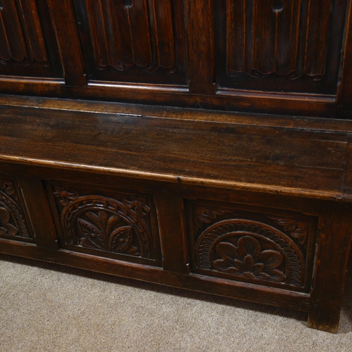 175 - A 19th century carved oak, linenfold, high-back settle/hall-stand, with shelf over hooks and box sea... 