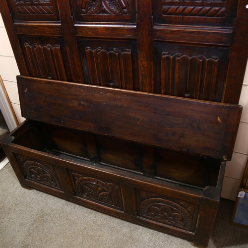 175 - A 19th century carved oak, linenfold, high-back settle/hall-stand, with shelf over hooks and box sea... 