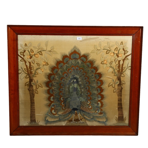 179 - Late 19th century woolwork embroidered picture, depicting a peacock and fruit trees, framed, overall... 